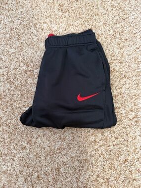 Nike Kids Black Joggers with Red Swoosh Accent